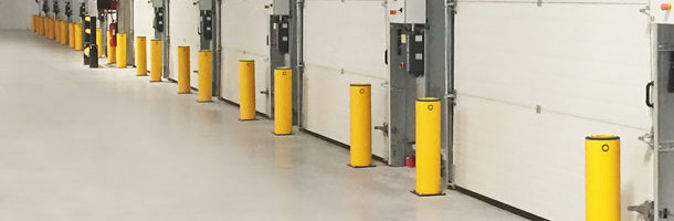 Safety bollards protecting industrial doors