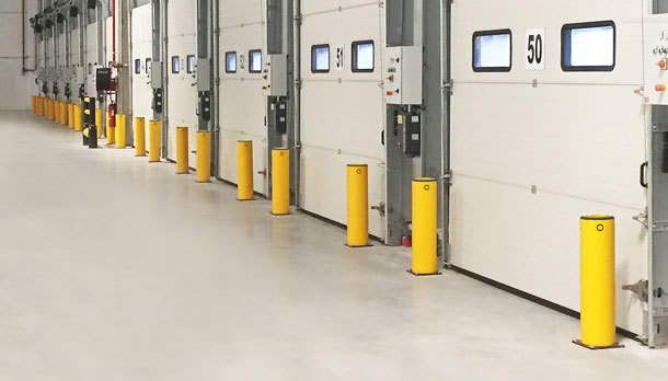 Safety bollards protecting industrial doors
