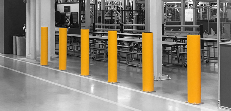 Concrete and Steel Bollards: Polymer bollards protecting machinery in a factory